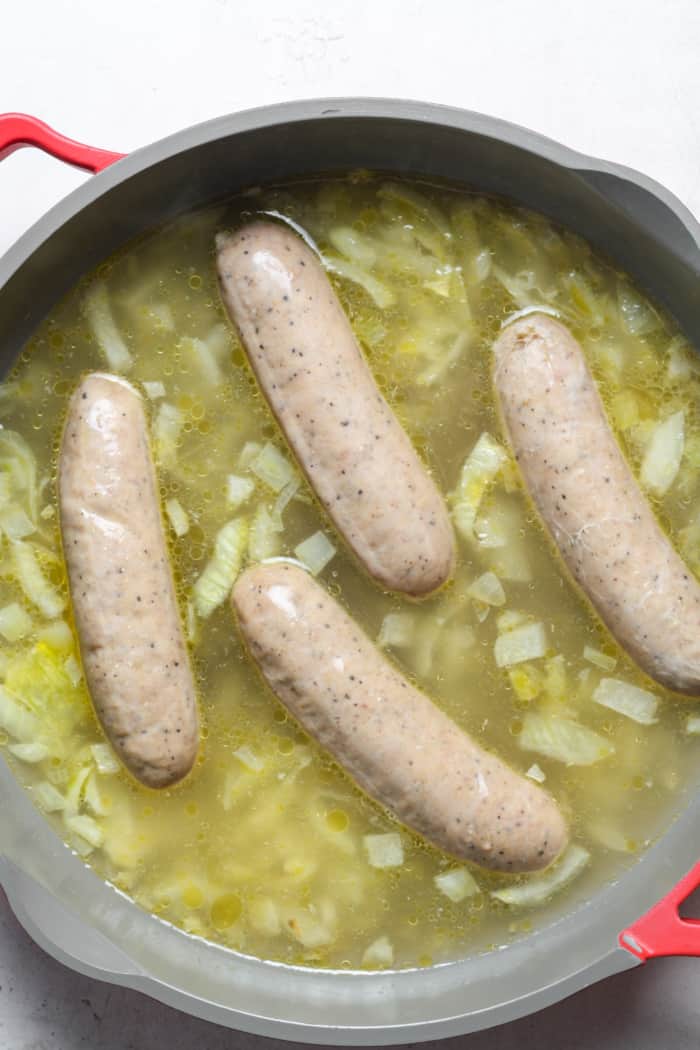 Sausage and broth in pan.