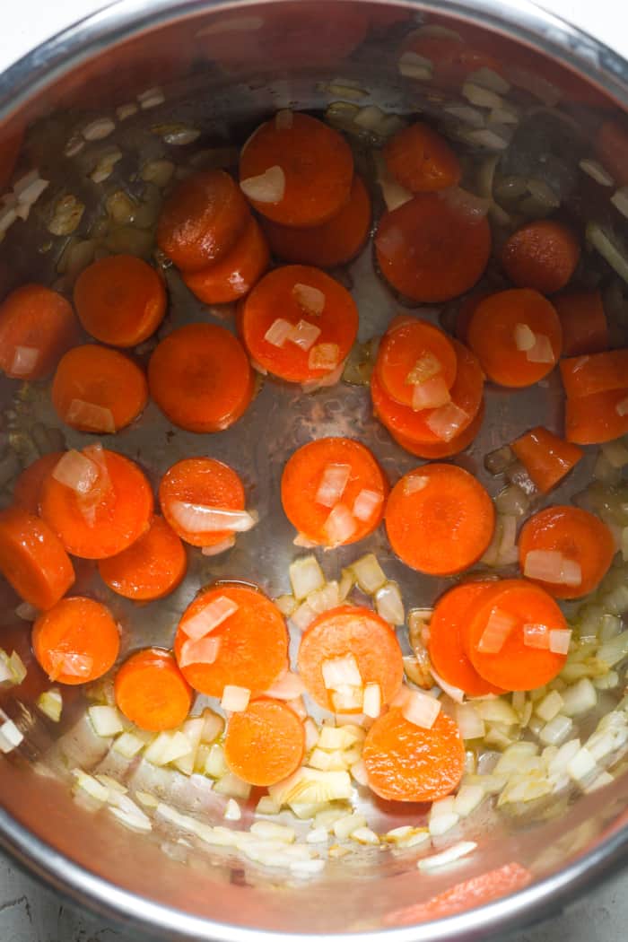 Carrots and onions in pot.