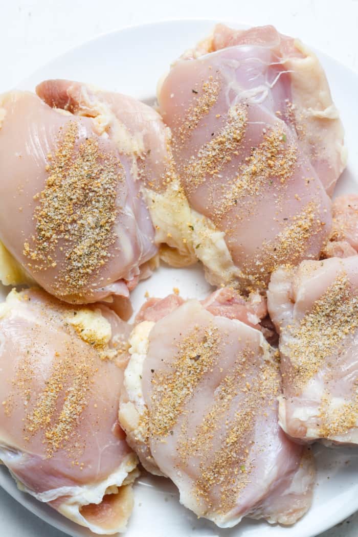 Chicken thighs with seasonings.