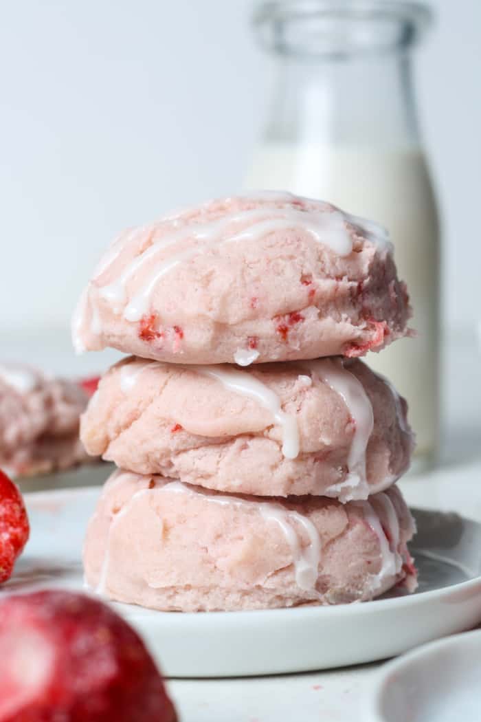 Stack of strawberry iced cookies.