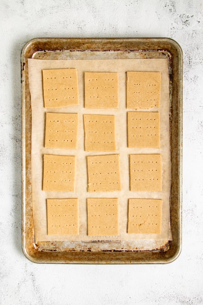 Raw graham crackers on pan.