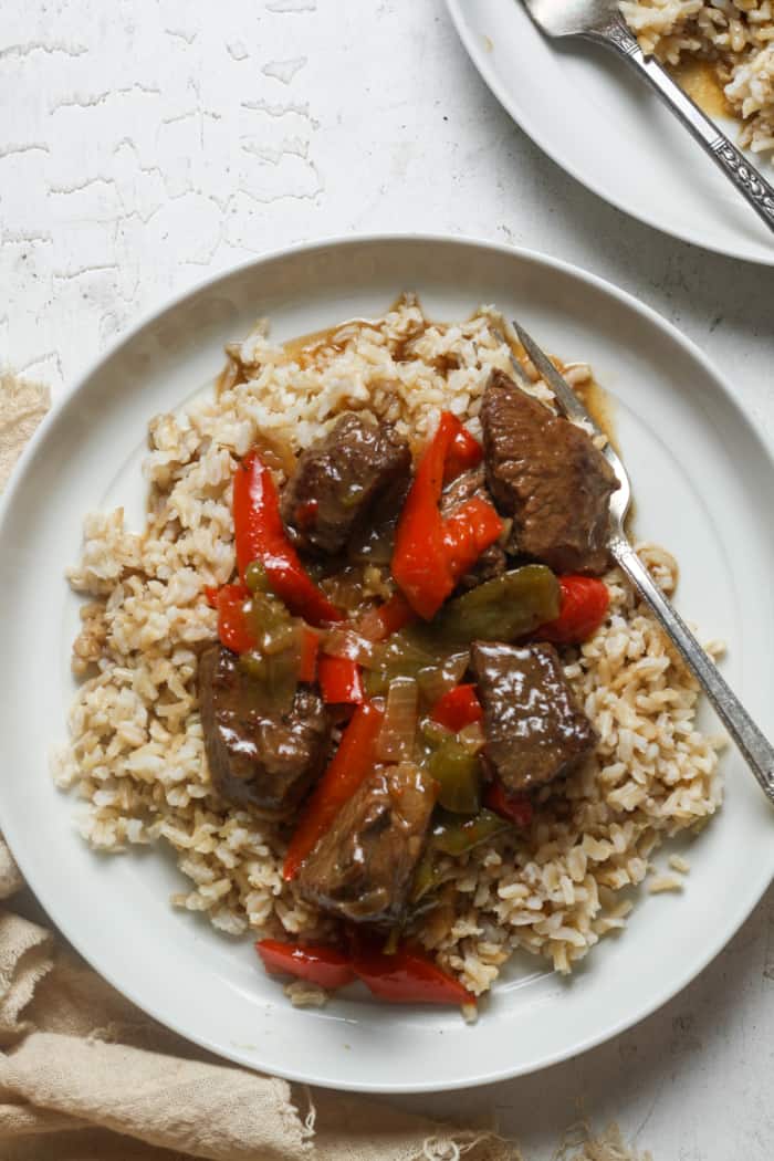 Beef tips and rice on plate.