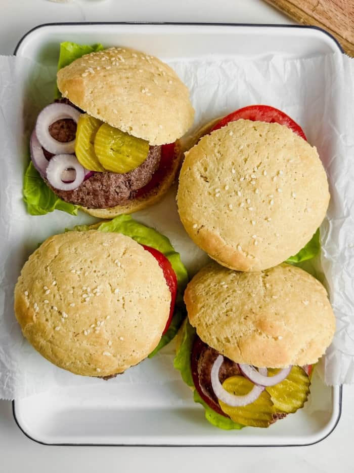 Platter of burgers with bread.