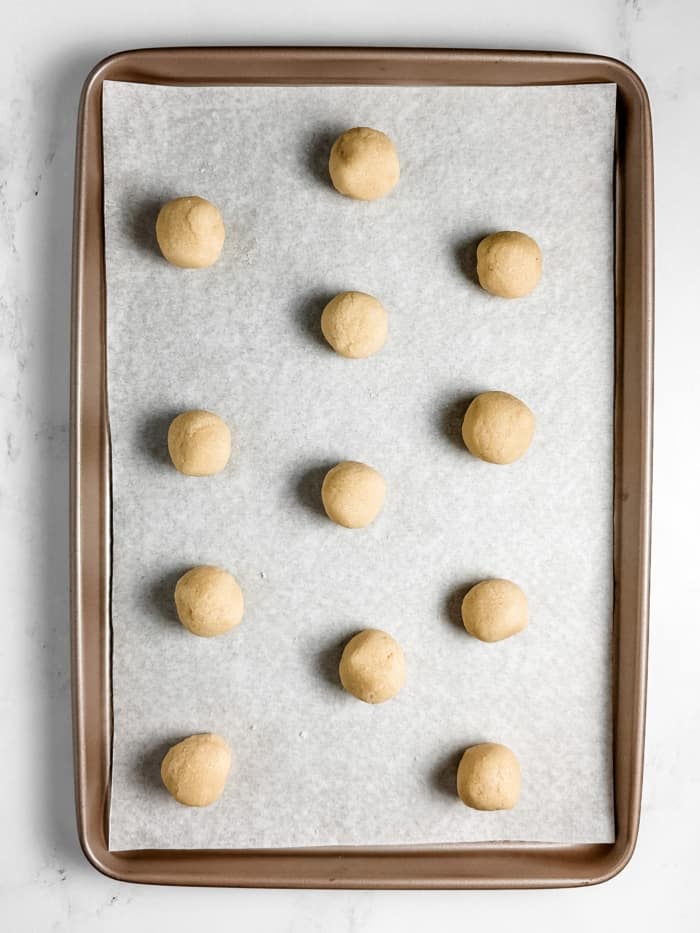 Group of dough balls on pan.