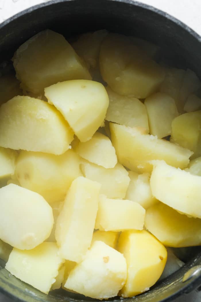 Soft potatoes in saucepan.