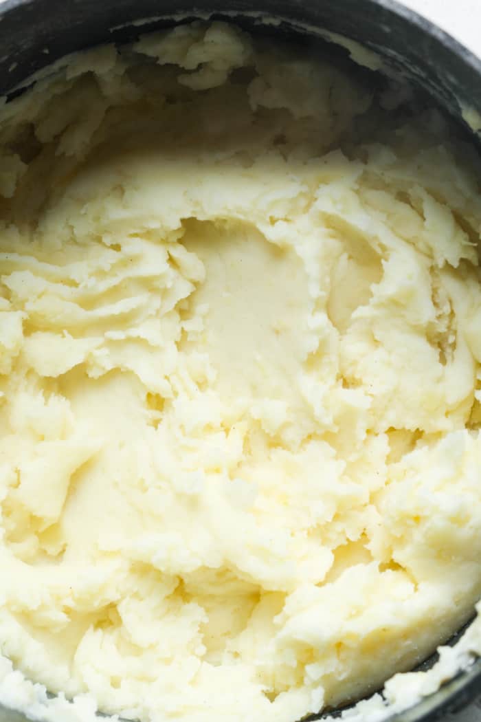 Creamy potatoes in pan.