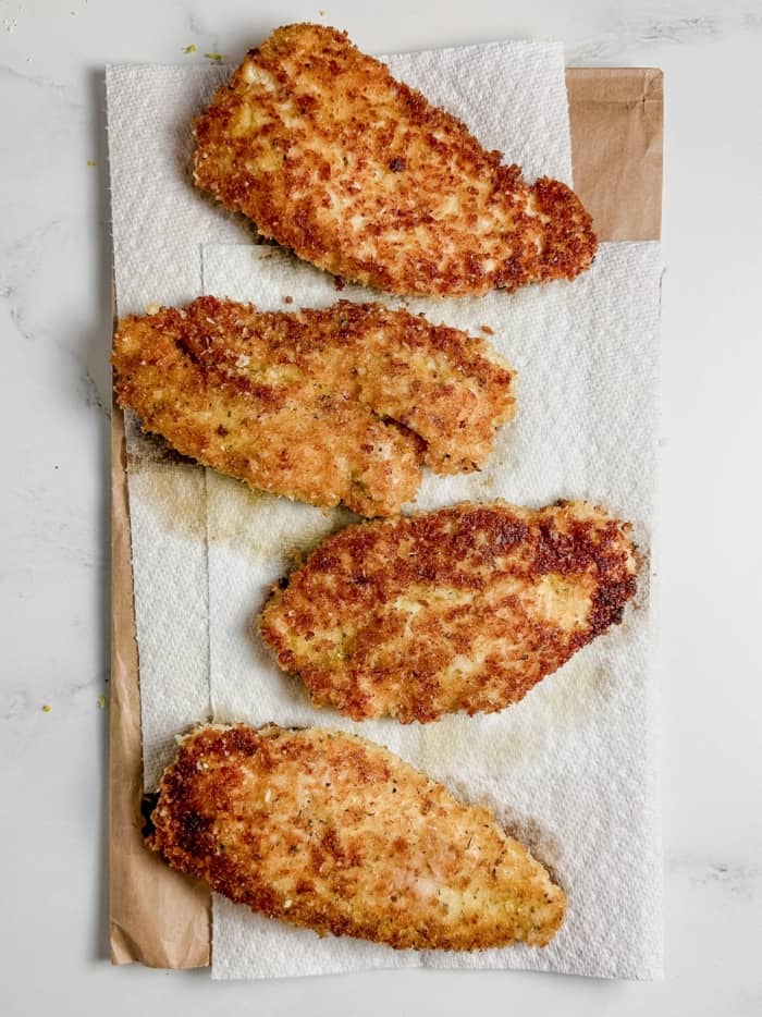 Parmesan chicken on paper towels.