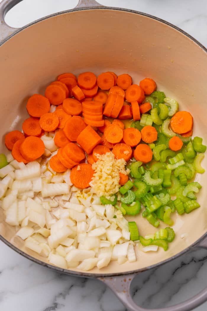 Chopped veggies and garlic in Dutch oven.