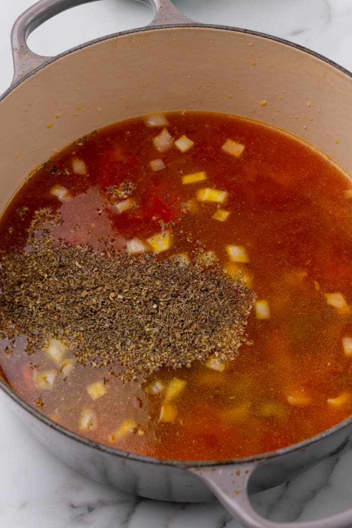 Broth and seasonings in Dutch oven.