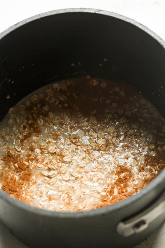 Oats and cinnamon in pan.