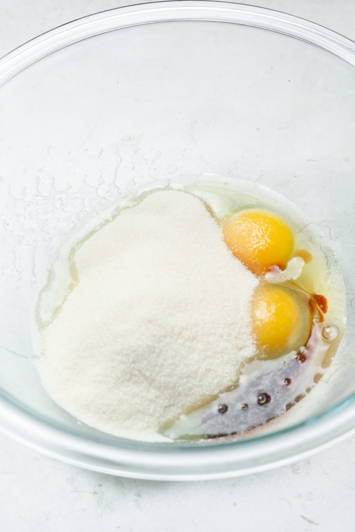 Glass bowl with eggs and sugar.
