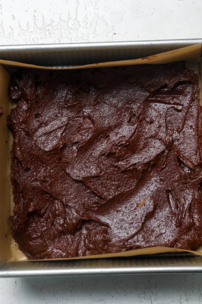Square pan with brownie batter.