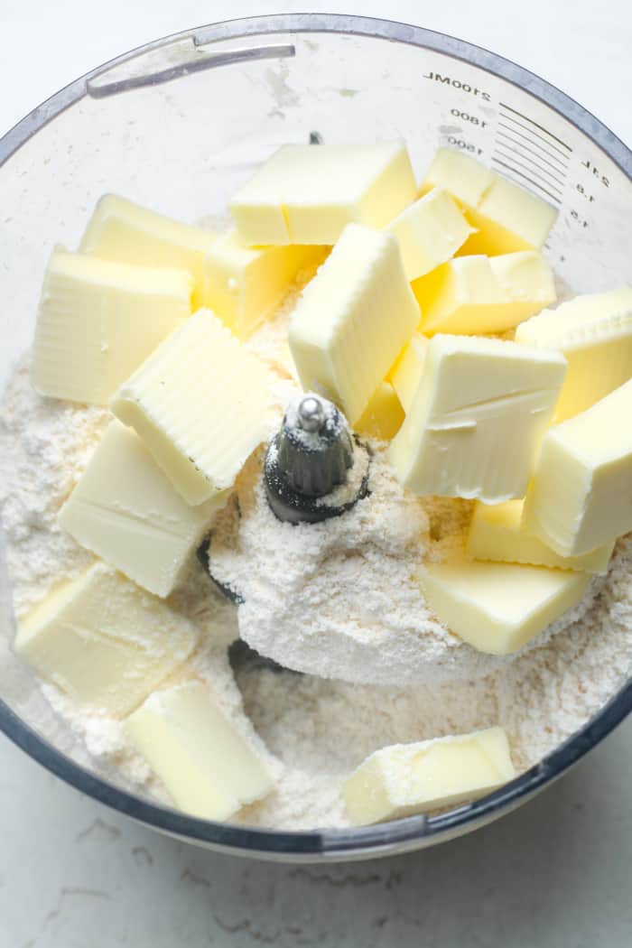 Butter cubes and flour in food processor.