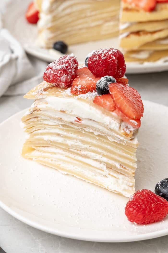 Slice of crepe cake with fruit.