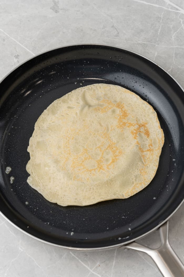Thin pancake in pan.
