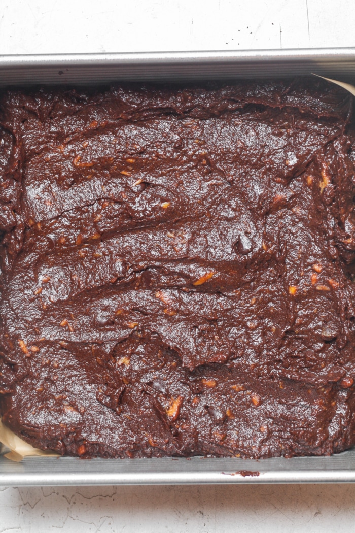 Square pan with chocolate batter.