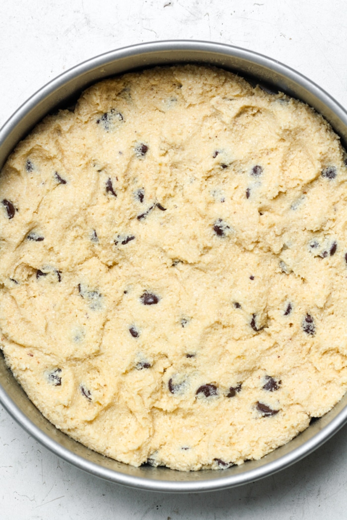 Cookie dough in cake pan.