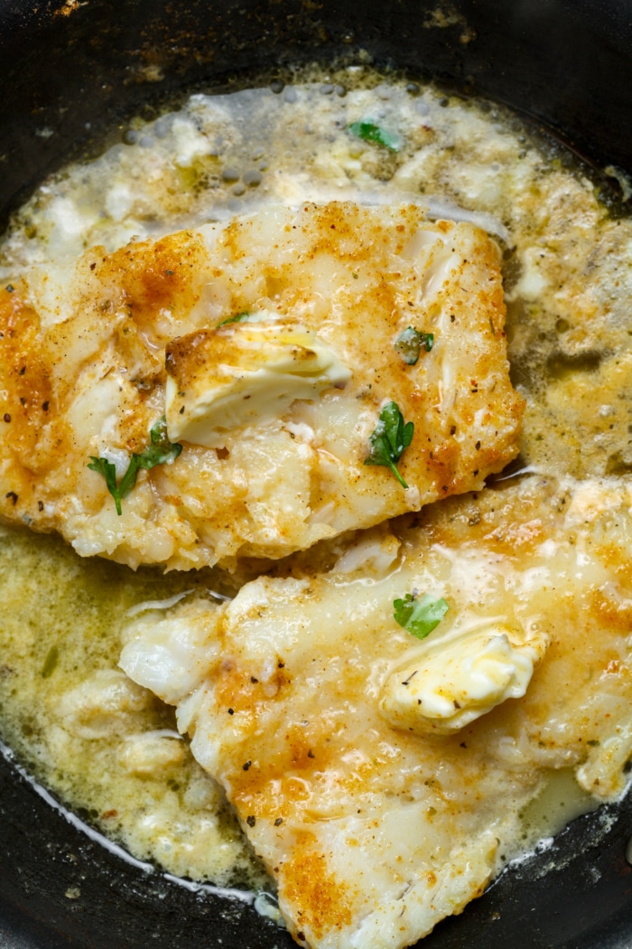 Buttery halibut in pan.