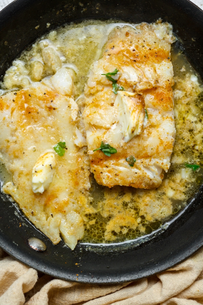 Skillet with white fish.