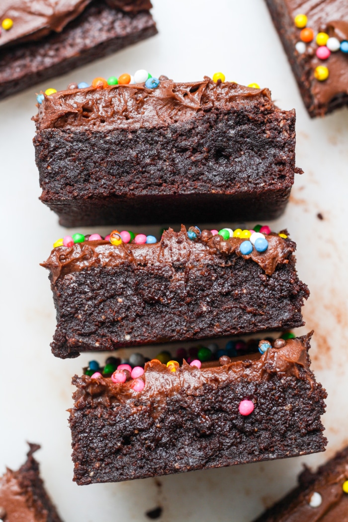 Stack of brownies with frosting.