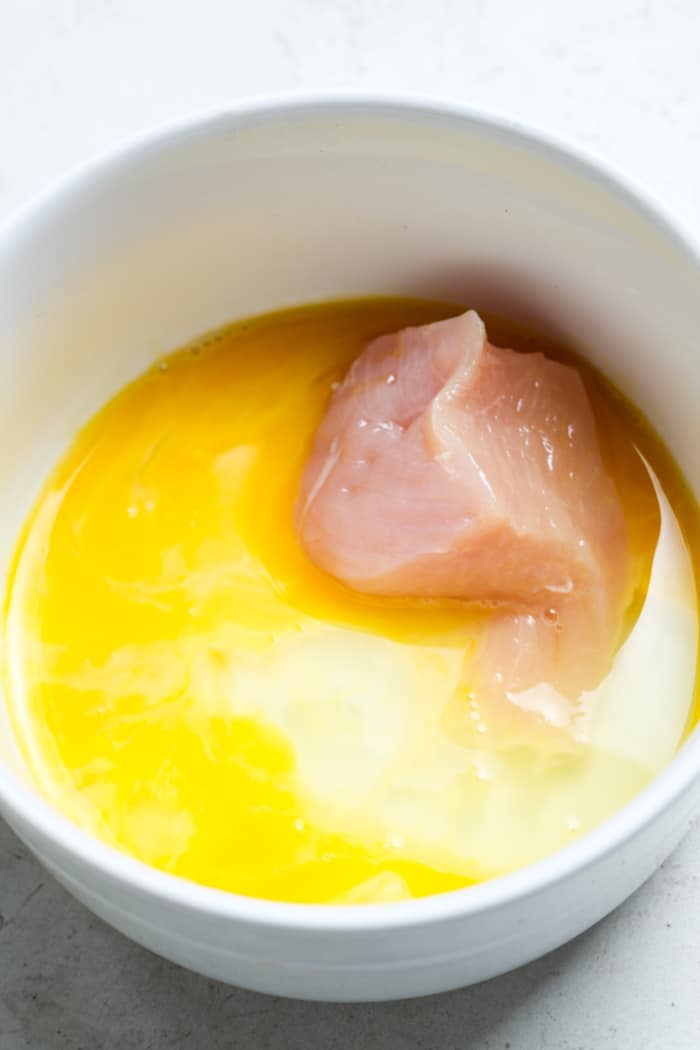 Piece of meat in egg wash.