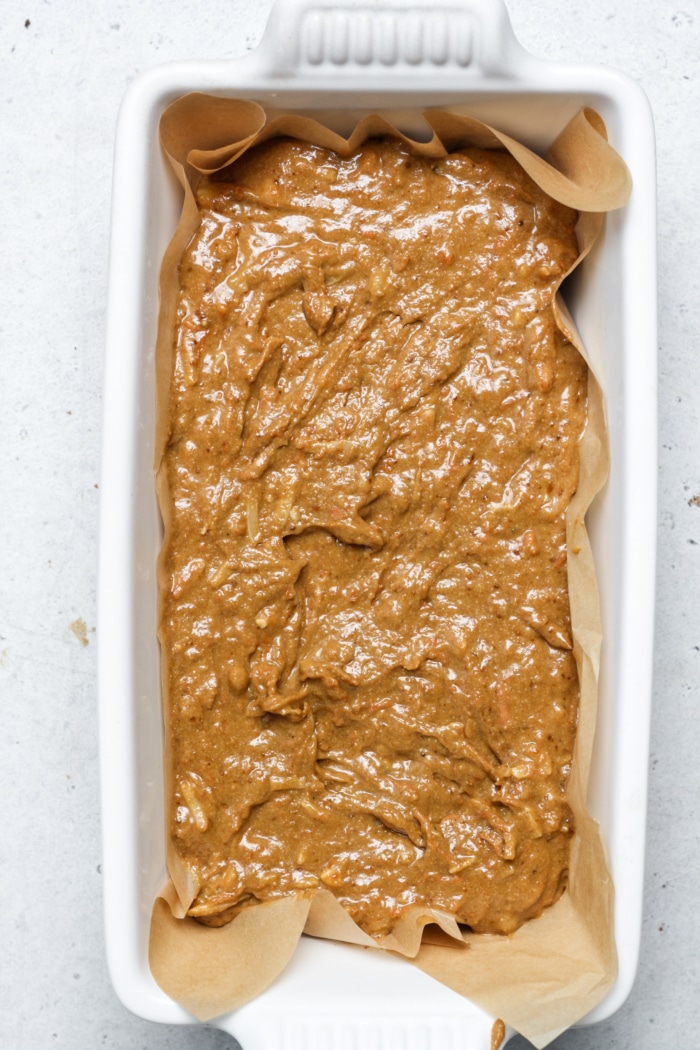 Loaf pan with orange batter.