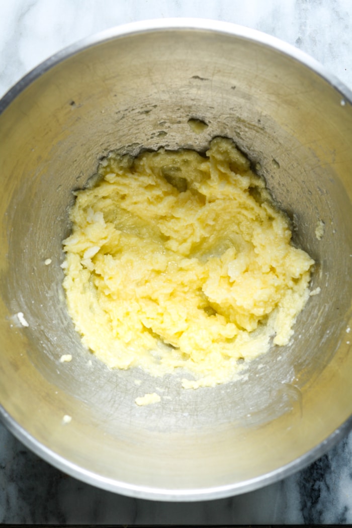 Yellow dough in mixing bowl.