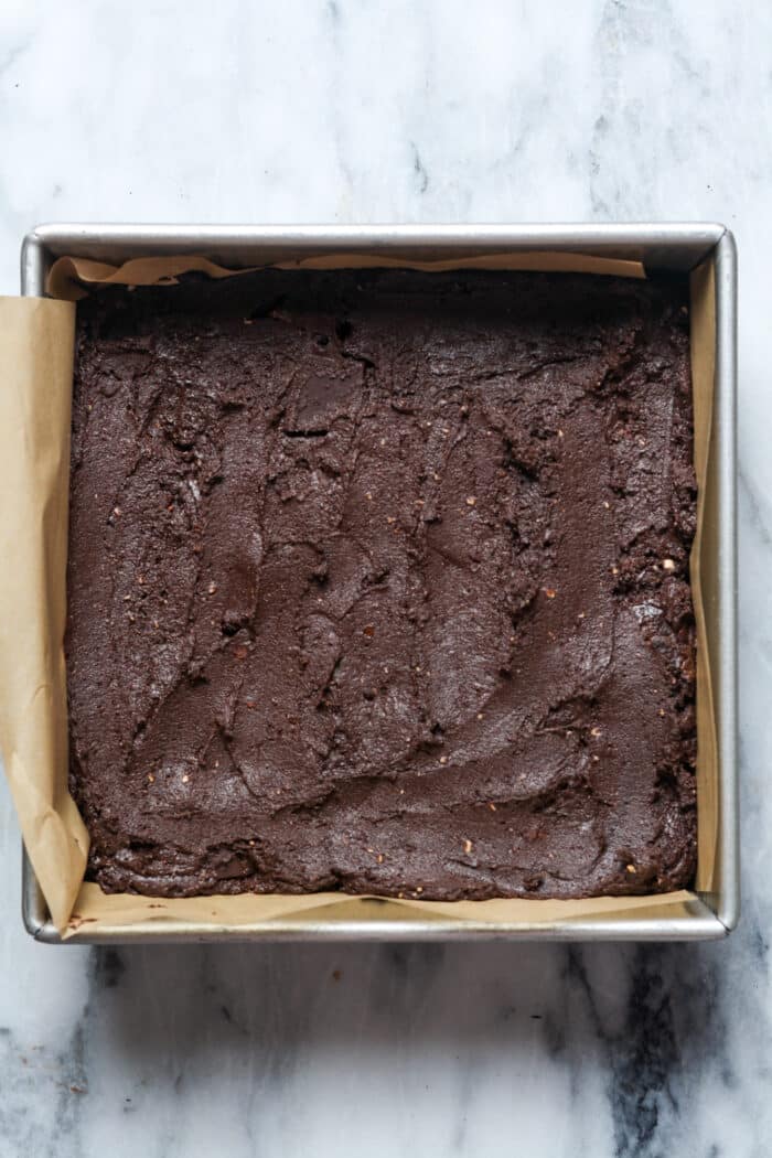 Brownie batter in square pan.