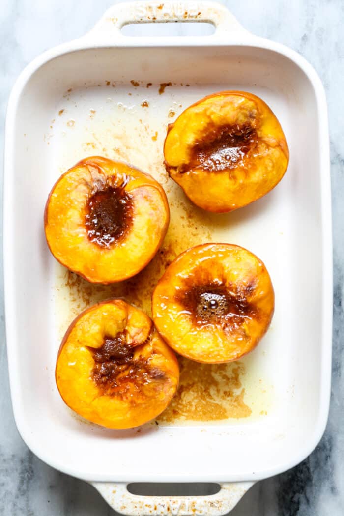 Baked peach in dish.