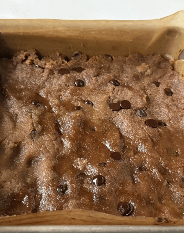 Cookie dough in square pan.