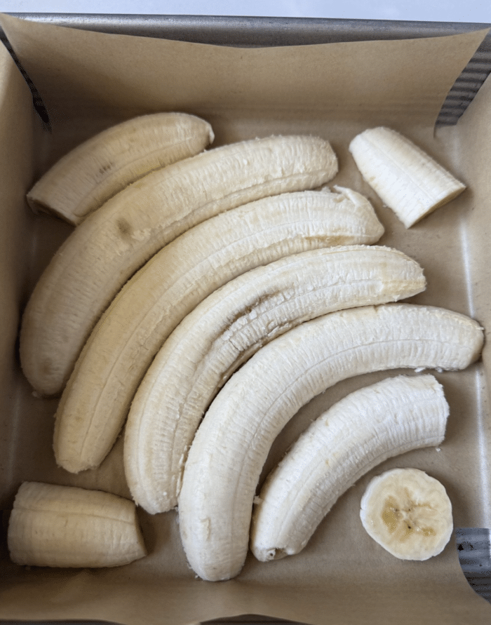 Sliced bananas in square pan.