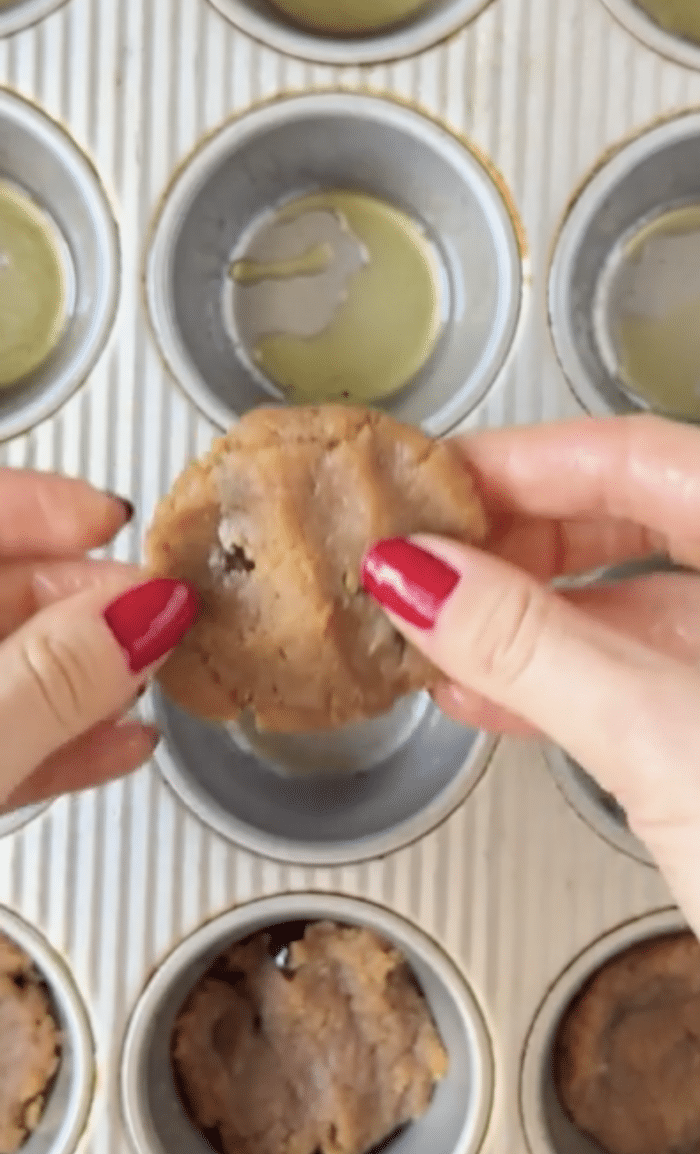 Fingers with cookie dough.