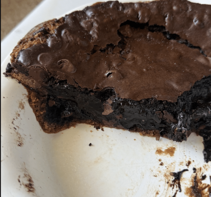 Gooey brownie in circle pan.