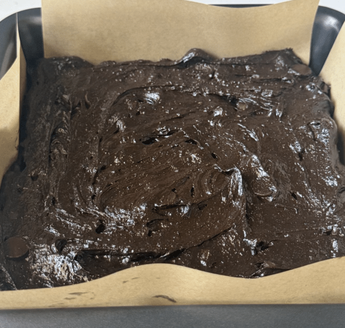 Batter spread in square pan.