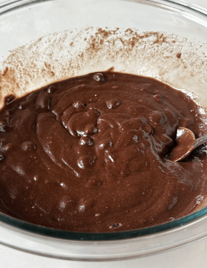 Dark chocolate batter in glass bowl.
