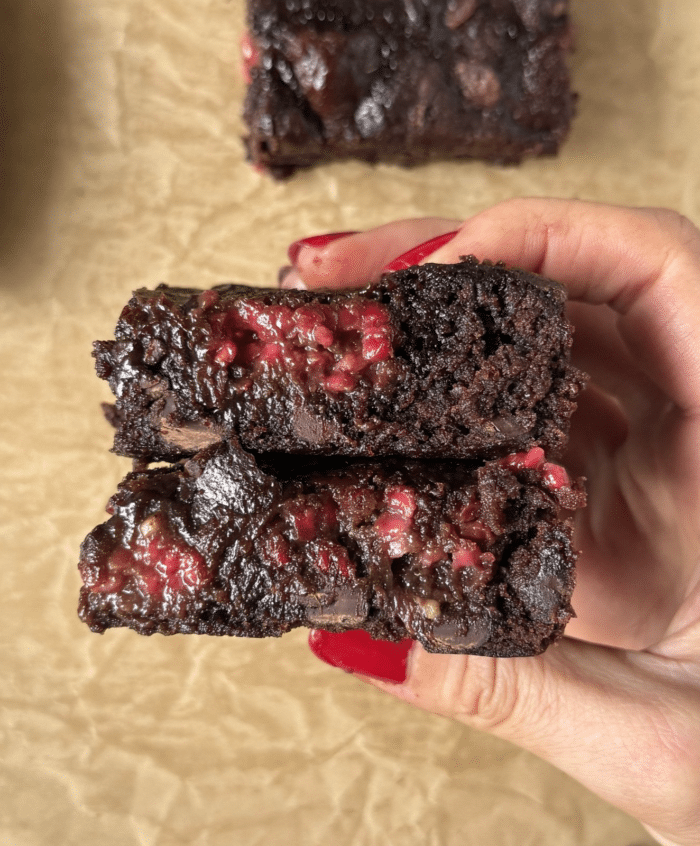 Hands with fruity brownies.