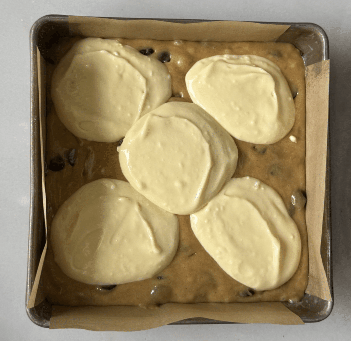 Cheesecake batter on cookie dough.