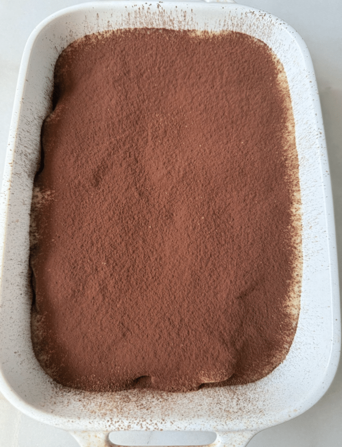 Frosting with cocoa dusting.