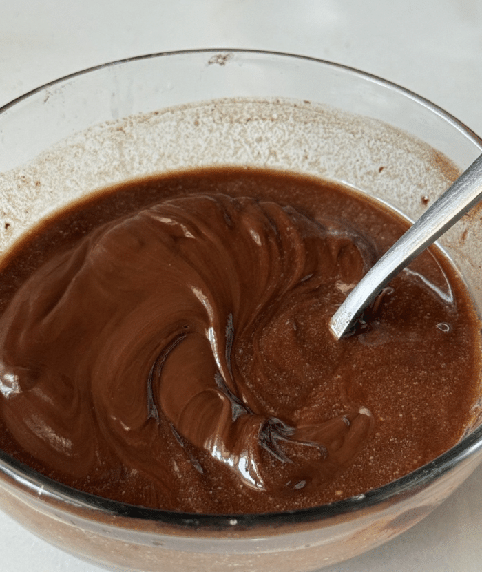 Melted chocolate in glass bowl.