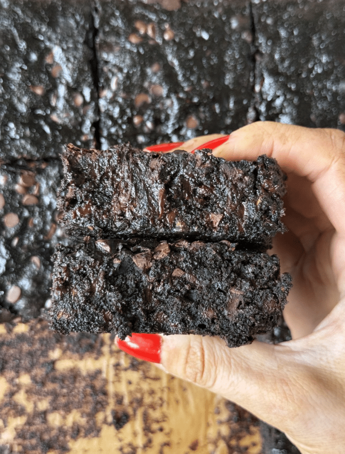 Hands with zucchini bars.