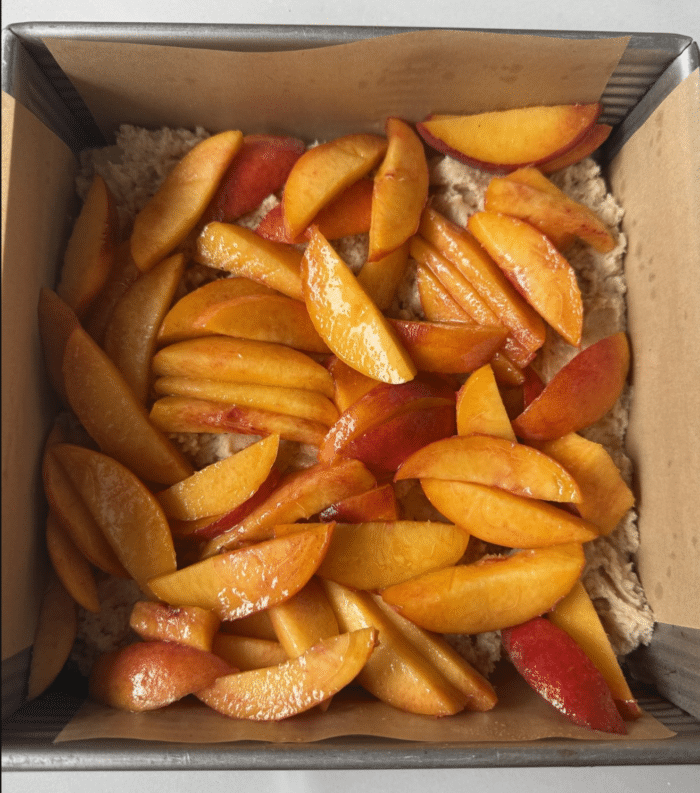Sliced peaches in pan.