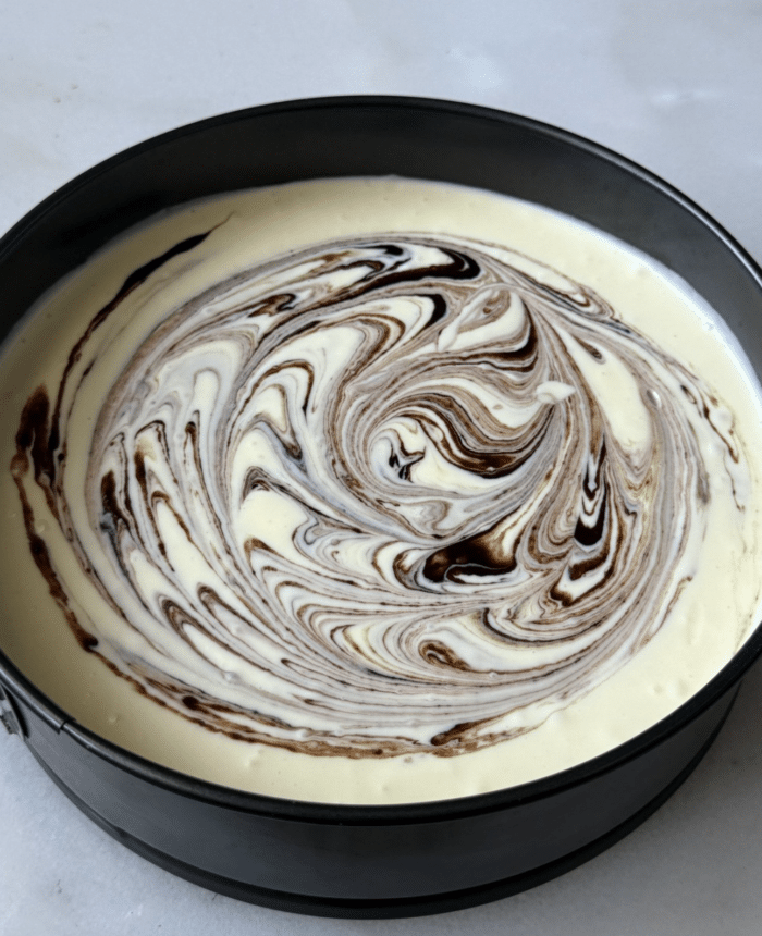 Swirled cheesecake dough.