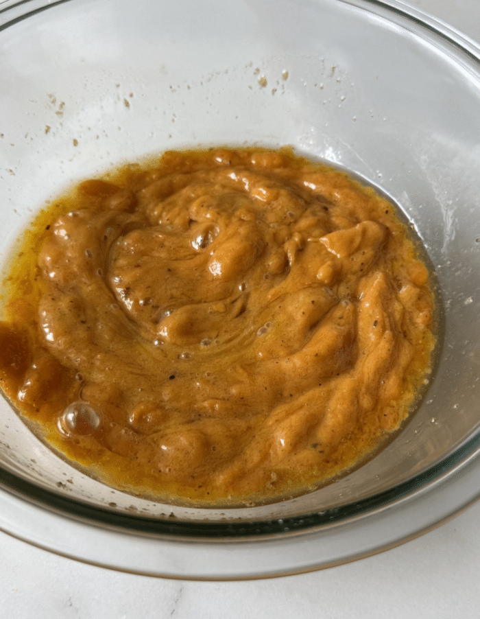 Orange batter in glass bowl.