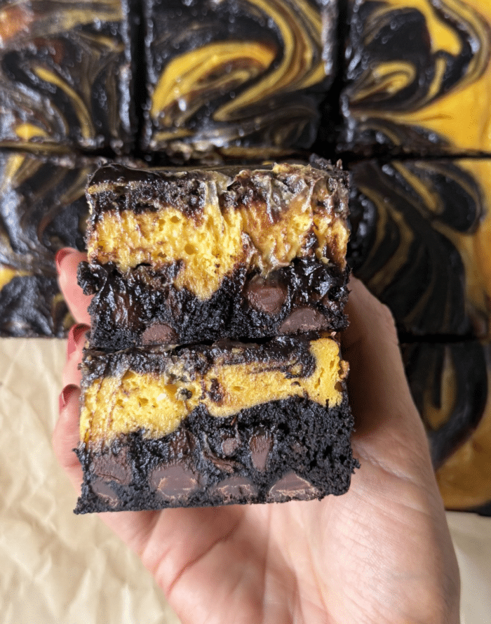 Stack of pumpkin cheesecake brownies.
