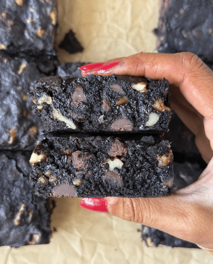 Hands with walnut brownies.