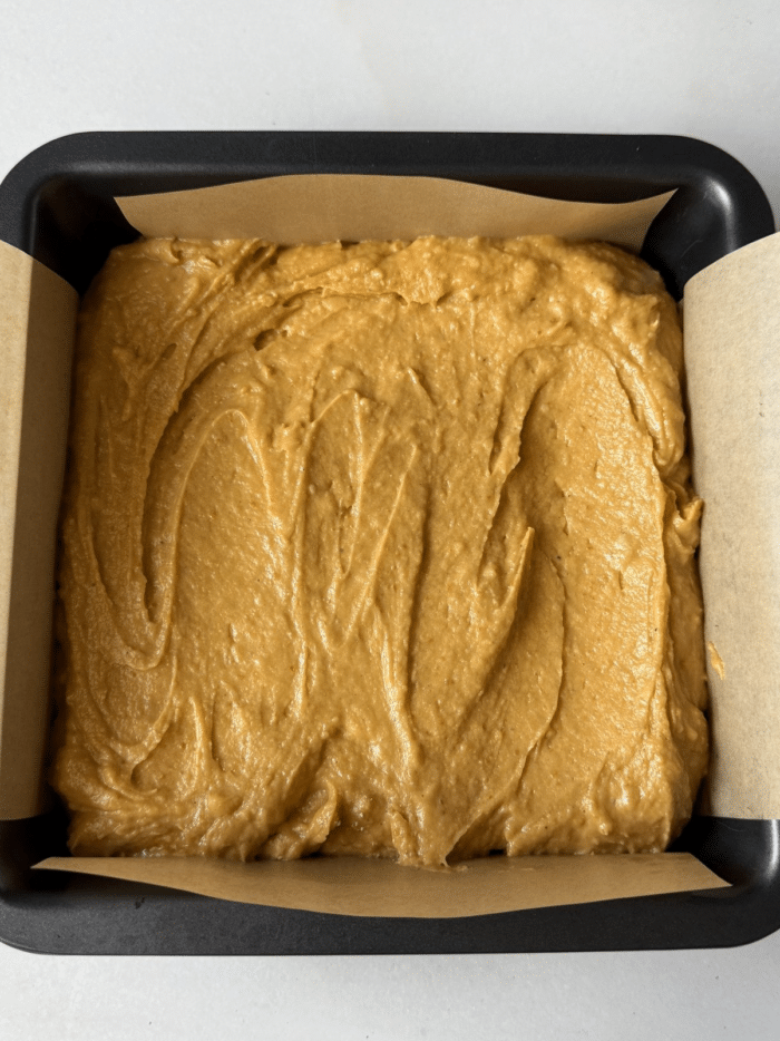 Orange batter in square pan.