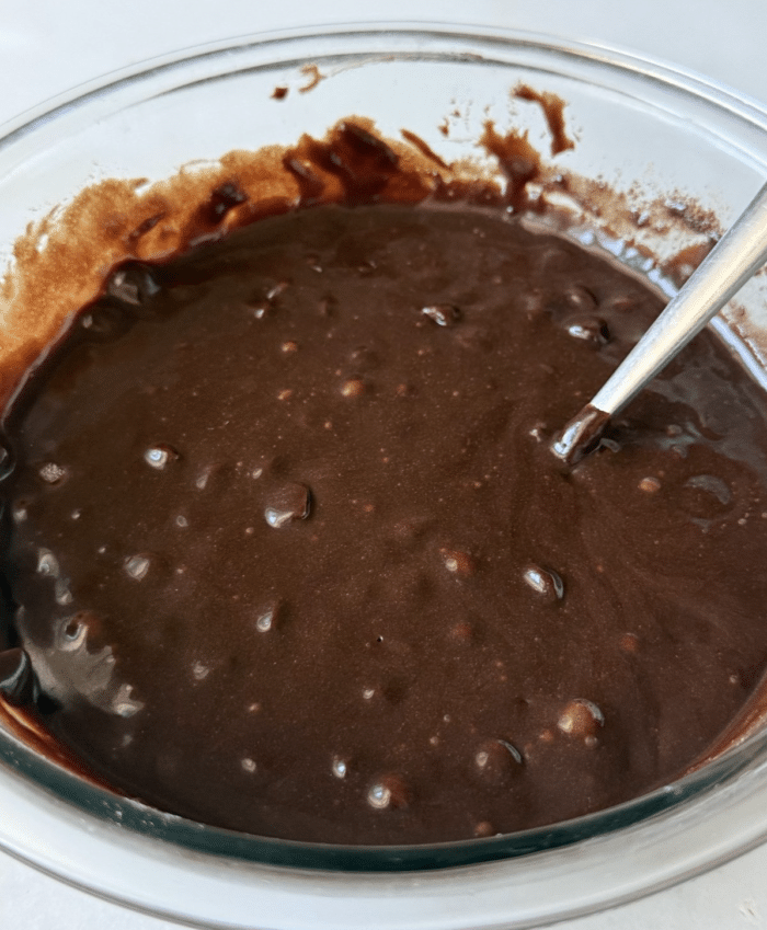 Fudge brownie batter in glass pan.